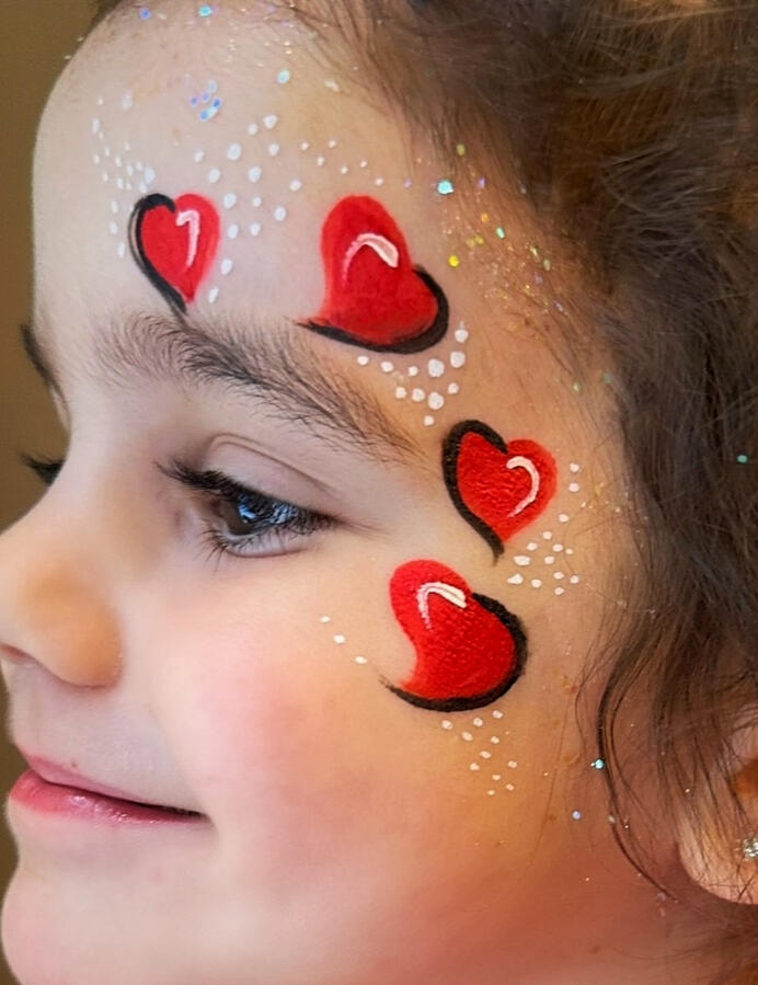 Valentine's day Face paint design with red hearts
